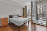 This cozy bedroom features a comfortable bed and ample natural light, perfect for relaxation.