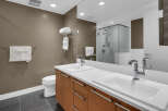 This modern bathroom boasts a sleek design with a double vanity and ample counter space, perfect for a luxurious lifestyle.