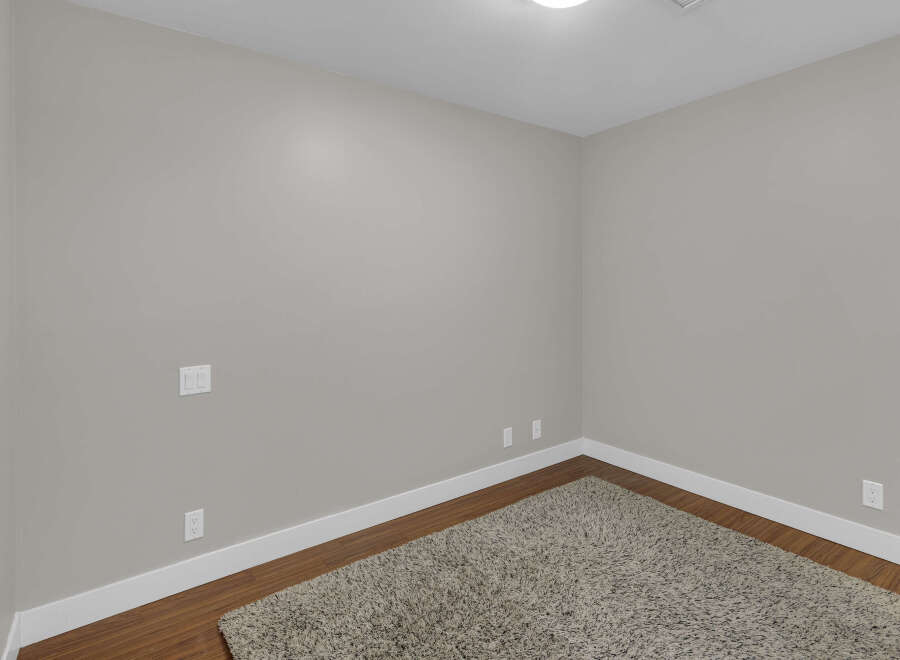 This inviting room showcases a neutral color palette, creating a versatile space ready for personalization.