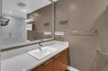 This modern bathroom features a sleek design with a white countertop and a stylish sink.