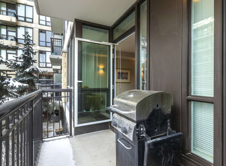 Enjoy outdoor living on this stunning balcony, complete with a grill for effortless entertaining.