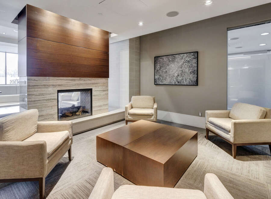 This stunning living space features a modern fireplace with a sleek wooden facade, creating a warm and inviting atmosphere.