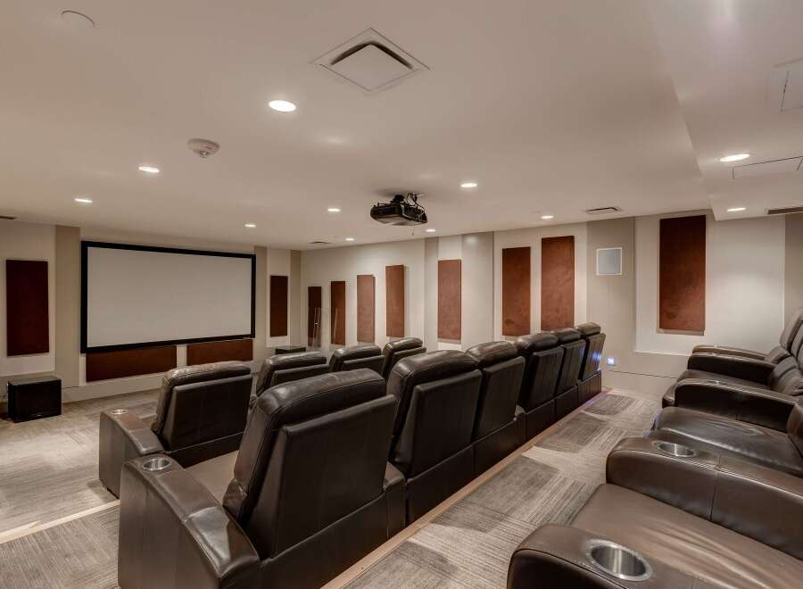 Step into luxury with this home theater! Featuring plush, leather seating and a large screen, it's perfect for movie nights.