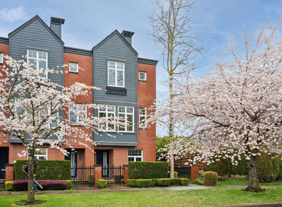 This stunning property boasts a modern design with a brick facade and stylish gray accents.