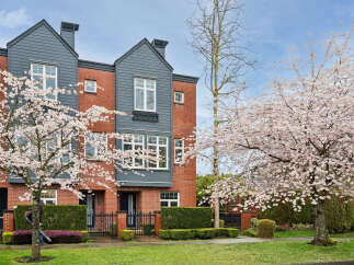 This stunning property boasts a modern design with a brick facade and stylish gray accents.