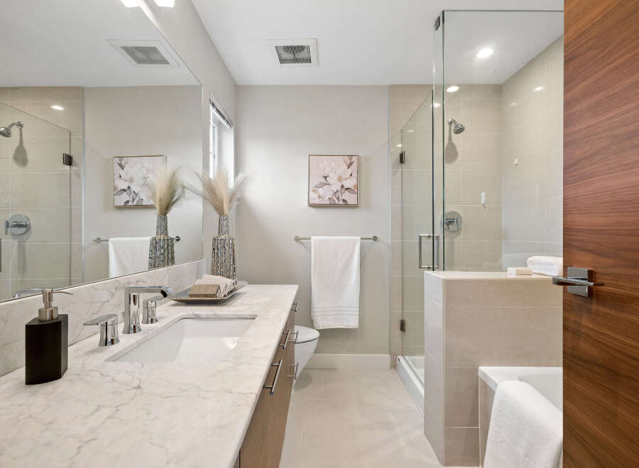 Step into a luxurious bathroom retreat, featuring a sleek marble countertop and modern fixtures.