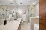 Step into a luxurious bathroom retreat, featuring a sleek marble countertop and modern fixtures.