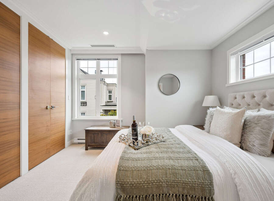 Step into luxury with this stunning bedroom, featuring a plush tufted headboard and elegant decor.