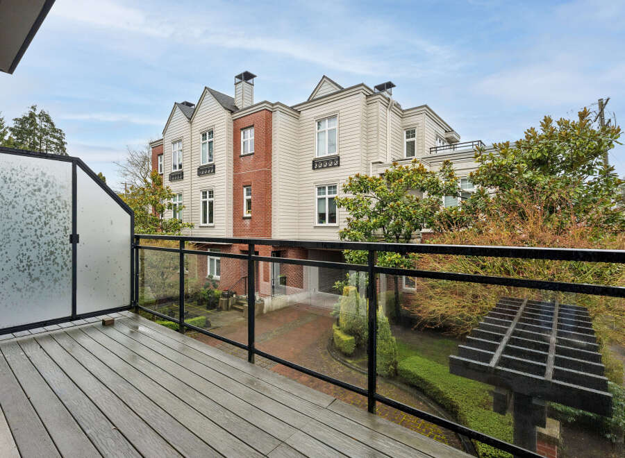 Enjoy stunning views from this beautiful property! This home features a spacious balcony with a modern glass railing, perfect for relaxing and taking in the surroundings.