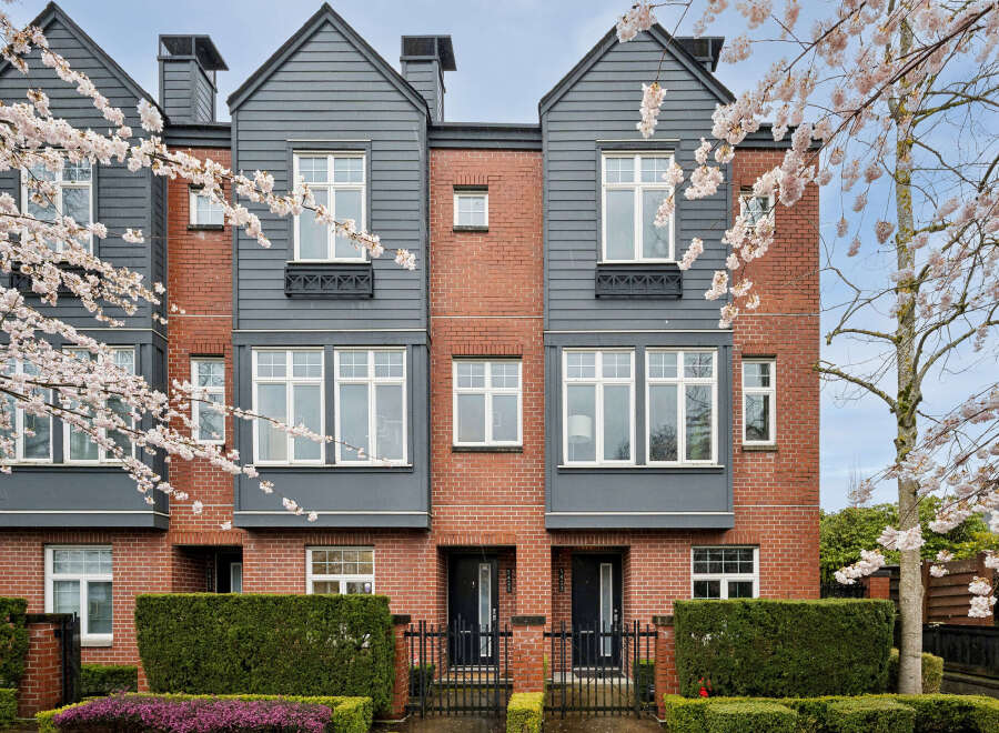 Discover modern living in this stunning townhouse, featuring a striking brick facade complemented by stylish gray accents.