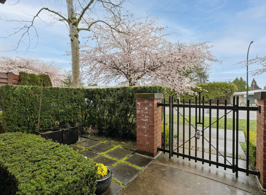Discover the charm of this beautiful property, featuring a welcoming entrance with a stylish black gate.