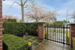 Discover the charm of this beautiful property, featuring a welcoming entrance with a stylish black gate.