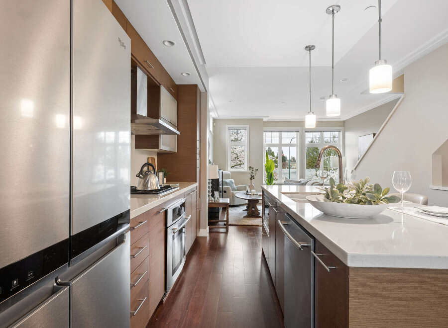 Step into modern elegance with this stunning kitchen! Featuring sleek stainless steel appliances, a spacious island, and beautiful hardwood floors, this space is perfect for both cooking and entertaining.