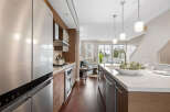 Step into modern elegance with this stunning kitchen! Featuring sleek stainless steel appliances, a spacious island, and beautiful hardwood floors, this space is perfect for both cooking and entertaining.