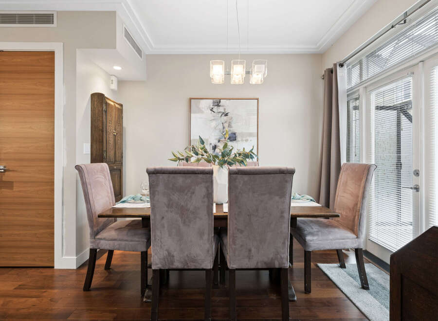 Step into luxury with this stunning dining room! Featuring a modern dining table with plush velvet chairs, this space is perfect for hosting memorable gatherings.