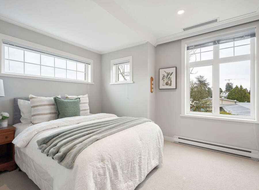 This stunning bedroom boasts a bright and airy ambiance, perfect for relaxation.