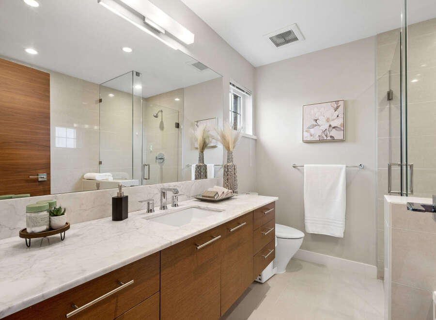 This stunning bathroom features a modern design with a sleek vanity and a spacious shower.