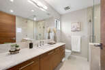 This stunning bathroom features a modern design with a sleek vanity and a spacious shower.