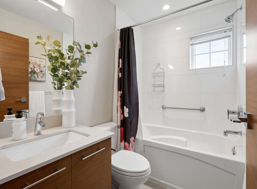 Step into a modern bathroom oasis! This space boasts a sleek vanity with ample storage, perfect for keeping essentials organized.
