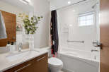 Step into a modern bathroom oasis! This space boasts a sleek vanity with ample storage, perfect for keeping essentials organized.