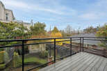 Enjoy stunning views from this beautiful property! This home features a spacious deck with a modern glass railing, perfect for relaxing and entertaining.