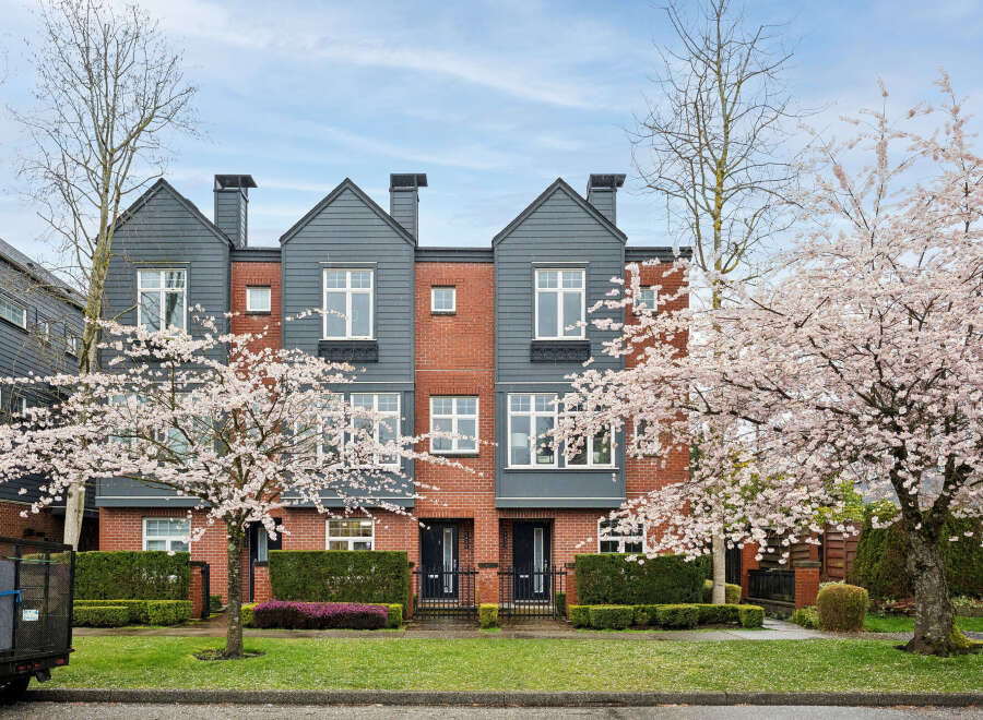 Discover modern living in this stunning townhome featuring a striking brick facade and stylish gray accents.
