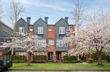 Discover modern living in this stunning townhome featuring a striking brick facade and stylish gray accents.