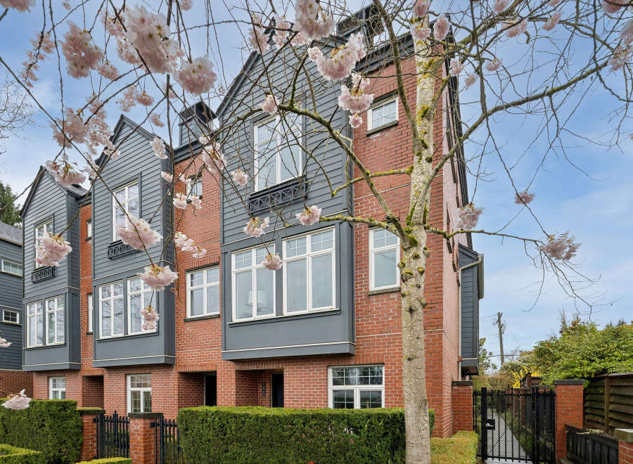 Discover modern living in this stunning townhome, featuring a beautiful brick facade and stylish gray accents.