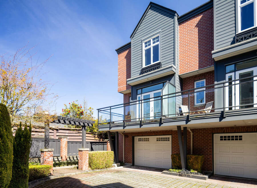This stunning property boasts a modern design with brick and gray siding, offering a blend of elegance and contemporary style.