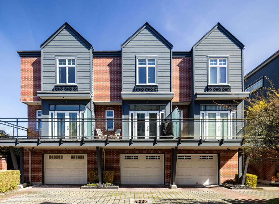 This stunning property features a modern design with three attached units, each boasting a unique facade.
