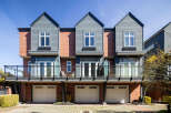 This stunning property features a modern design with three attached units, each boasting a unique facade.