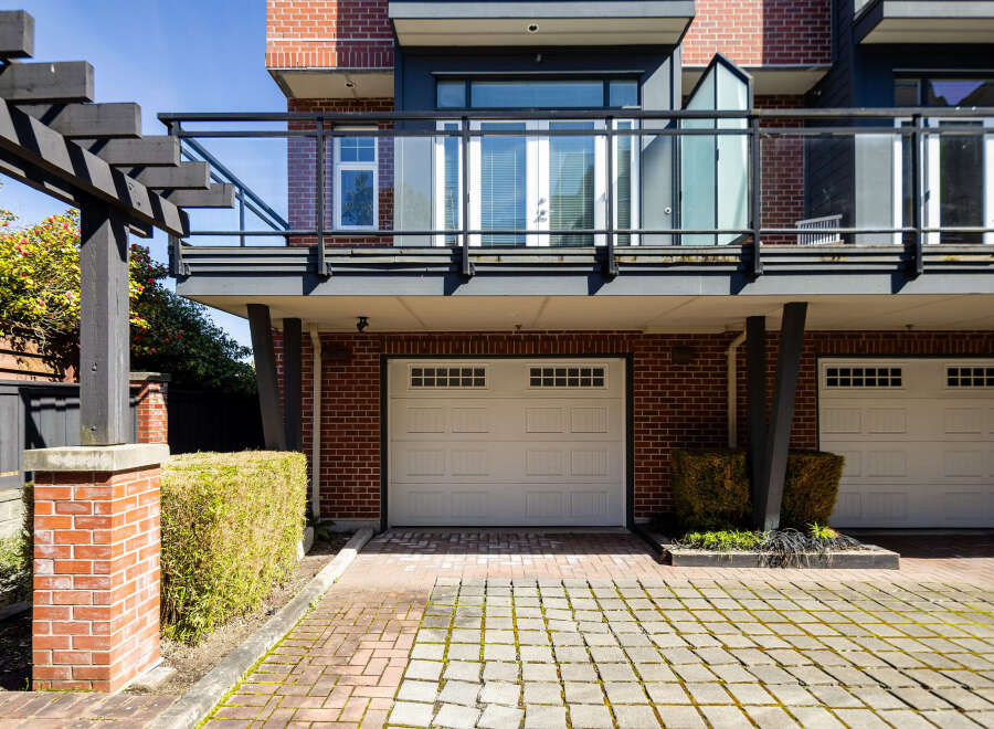 This stunning property boasts a modern design with a brick facade and a sleek balcony.