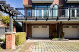 This stunning property boasts a modern design with a brick facade and a sleek balcony.