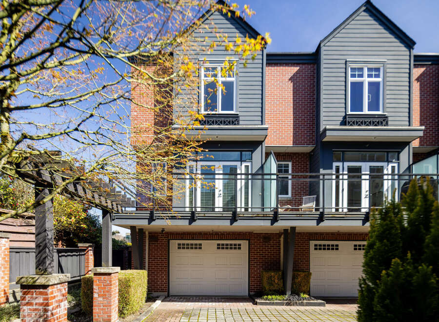 Discover modern living in this stunning townhome, featuring a stylish exterior with brick and siding.