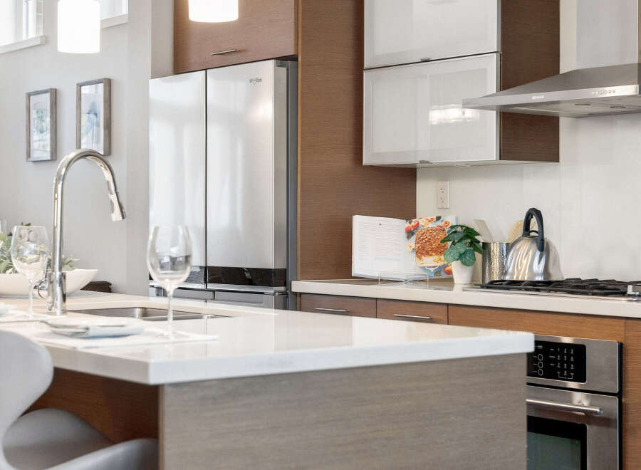 This modern kitchen boasts sleek design and high-end appliances, perfect for culinary enthusiasts.