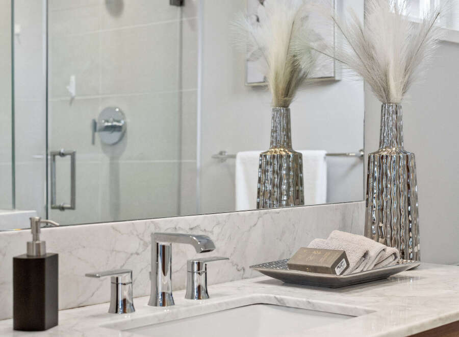 This stunning bathroom features a modern design with a sleek marble countertop and a stylish sink.