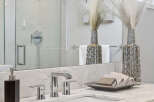 This stunning bathroom features a modern design with a sleek marble countertop and a stylish sink.