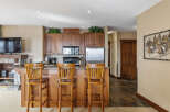 This stunning kitchen features a breakfast bar with seating for three, perfect for casual dining or entertaining.