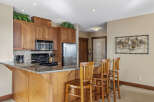 This stunning kitchen boasts beautiful wooden cabinetry, a sleek granite countertop, and modern appliances.