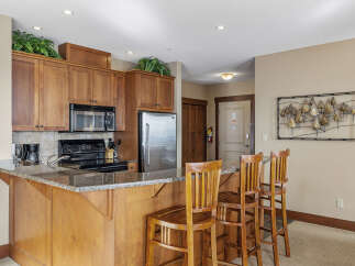 This stunning kitchen boasts beautiful wooden cabinetry, a sleek granite countertop, and modern appliances.