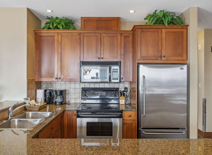 This stunning kitchen boasts beautiful wooden cabinetry, offering ample storage space.