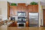 This stunning kitchen boasts beautiful wooden cabinetry, offering ample storage space.