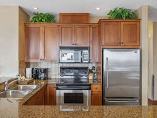 This stunning kitchen boasts beautiful wooden cabinetry, offering ample storage space.