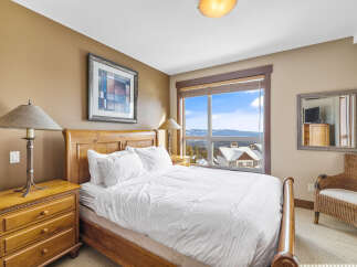 Experience the ultimate comfort in this cozy bedroom, featuring a plush bed and a stunning view.