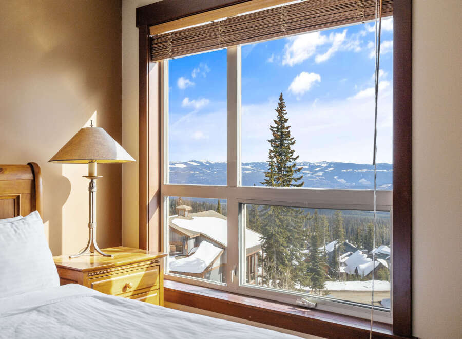 Enjoy breathtaking mountain views from this cozy bedroom.