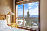 Enjoy breathtaking mountain views from this cozy bedroom.