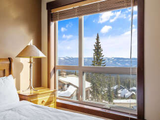 Enjoy breathtaking mountain views from this cozy bedroom.
