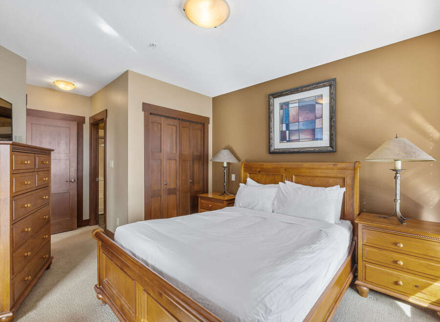 This inviting bedroom features a cozy bed, perfect for a relaxing retreat.
