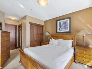 This inviting bedroom features a cozy bed, perfect for a relaxing retreat.