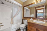 This stunning bathroom features a modern design with a sleek white bathtub and a stylish vanity.